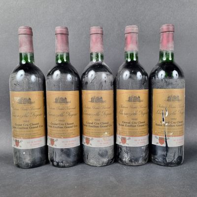 four bottles of wine are lined up in a row