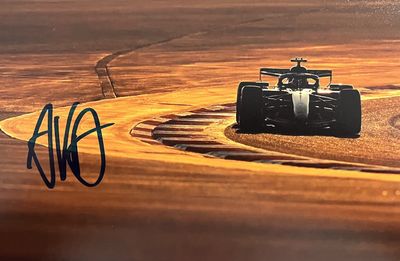 une photo d'une voiture de course qui file sur le circuit