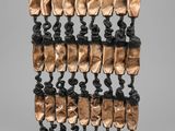 a close up of a sculpture on a stand with many pieces of metal