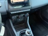 the interior of a car with a touch screen and steering controls
