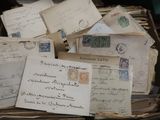 a box full of old letters and envelopes on a table