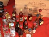 many bottles of liquor on a table with a wooden box
