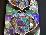 two packs of pokemon trading cards are on display in a box