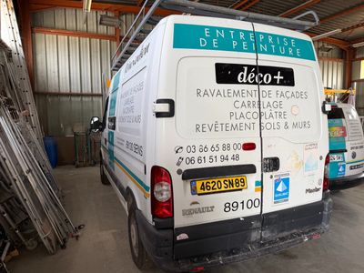 two vans that are parked in a garage