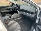 the interior of a car with the door open and a steering wheel in the passenger seat