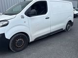 a white van parked in front of a building