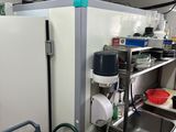a kitchen with a sink, refrigerator, and other items in it