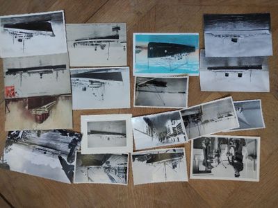 several black and white photographs of people on a wooden table