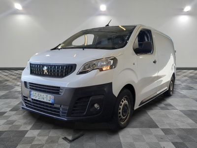 the white van is parked in a large room with a checkered floor