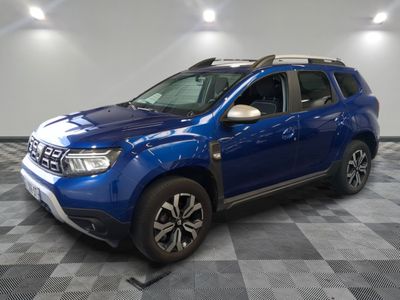 the blue dacia is parked on a checkered tile floor