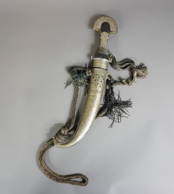 une vieille dague ornée d'un serpent, accrochée au mur