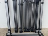 a group of metal poles sitting on top of a floor next to a wall