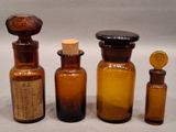 several bottles of various sizes and shapes are lined up