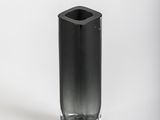 a black vase that is sitting on a white surface