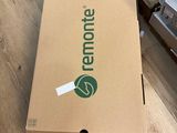 the box is sitting on the floor in front of a pile of boxes
