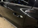 a close up of a car door handle with a sticker on it