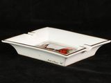 a small white bowl with a red flower in it