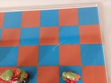 a blue and red checkered board with cupcakes on it