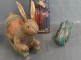 a statue of a rabbit sitting next to a figurine of a man