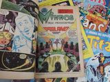 many comic books spread out on a table