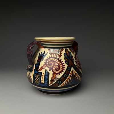 a vase with a design on it on a gray surface