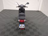 a motor scooter that is parked in a room