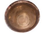 a small metal bowl on a white surface