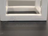 a close up of a small white box on a table