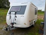 an image of a camper trailer parked in a field
