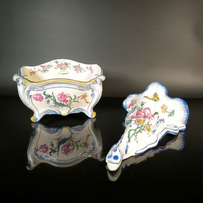 two pieces of porcelain are sitting on a black surface