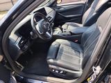 the interior of a car with the door open and the driver ' s seat down