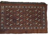 a close up of a brown and blue rug on a white background