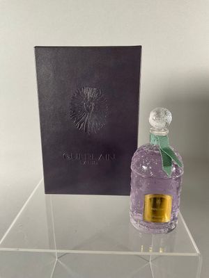 the perfume bottle is next to the box on the table