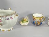 three cups and a saucer sitting next to each other