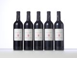 four bottles of wine are lined up on a table