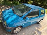 a small blue car that is parked on the side of the road