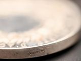 a close up of a silver plate on a table