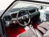 dashboard of a car with red carpeting and a steering wheel