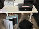 a lot of electronic equipment on a table in a room