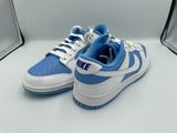 Baskets Nike Dunk Low bleues et blanches sur un fond blanc