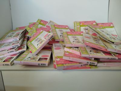 a pile of pink and yellow tickets sitting on top of a table