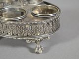 a silver plate with four bowls on it