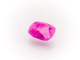 a close up of a pink diamond on a white surface