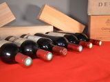 several bottles of wine are lined up in a row on a table