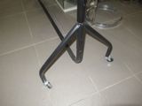 an image of a table with a glass top and metal legs