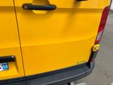 a close up of a yellow van parked in a parking lot