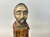 a wooden statue of a man with a beard