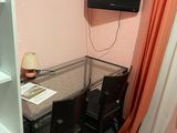 a small table with chairs and a television on the wall