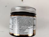 a close up of a jar of food on a white surface