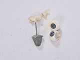 two pairs of earrings that are on a white surface